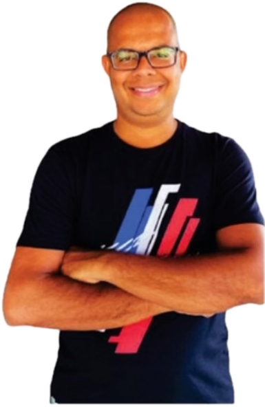 Prof. Plínio Neto sorrindo, de camiseta azul-marinho e braços cruzados